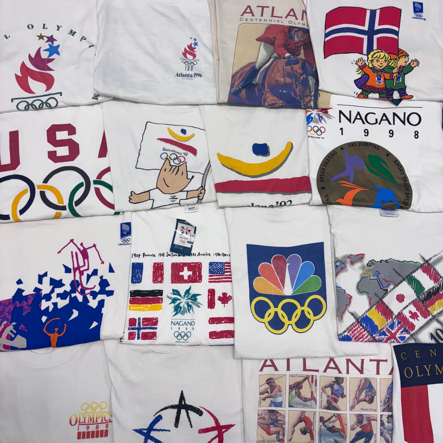 A selection of white vintage olympics t-shirts